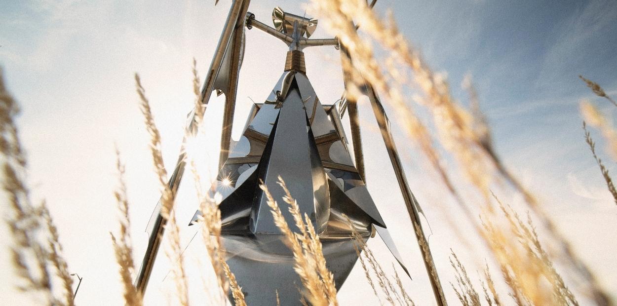 Blue sky with silver metal statute of a praying mantis, titled the Mantis Queen